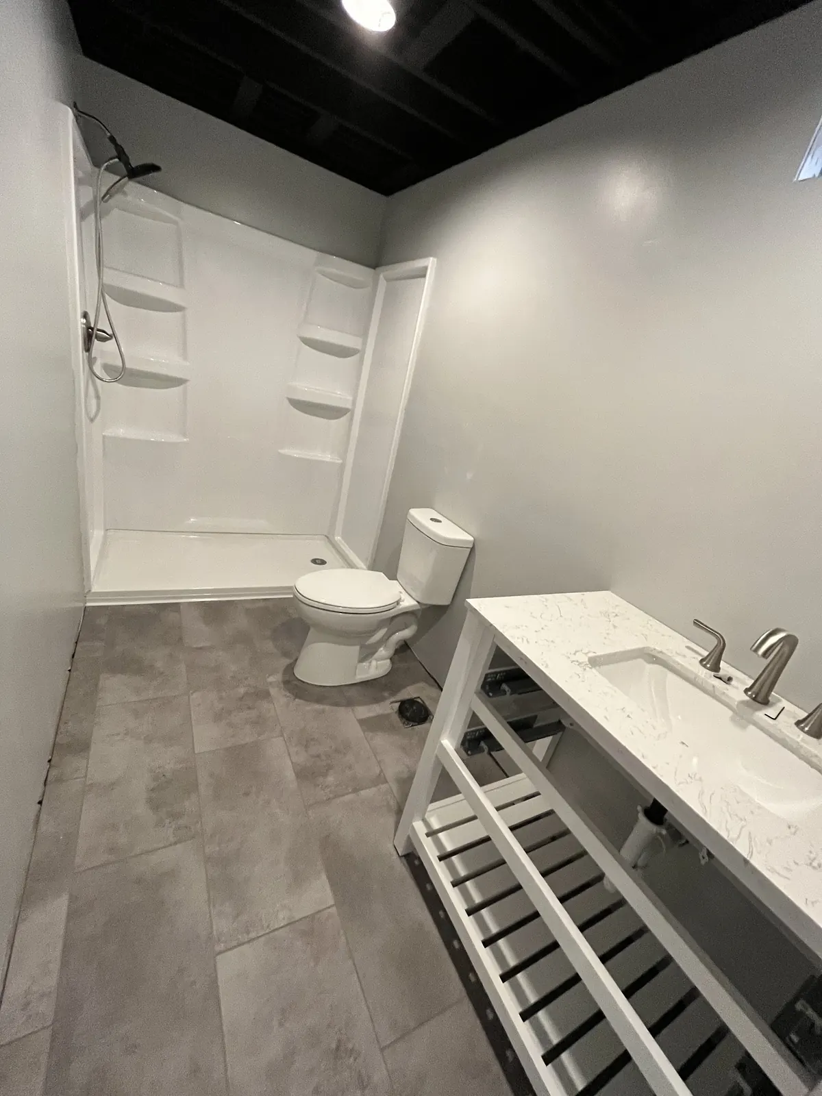 Finished basement bathroom with a new shower, toilet and vanity